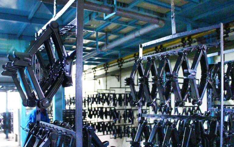 Parts on hangers moving along an ED coating conveyor