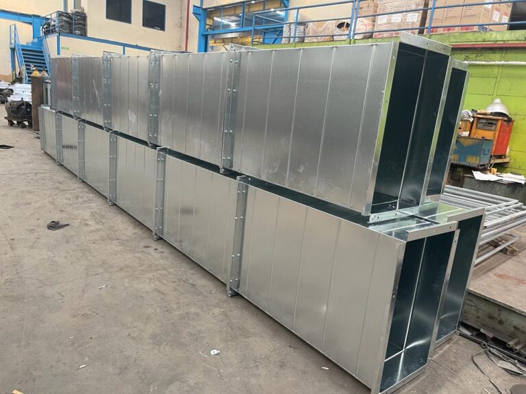 Painting booth panels during fabrication for a customer in Cikarang
