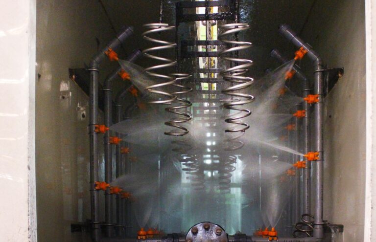 Spray nozzles inside a pre-treatment tunnel