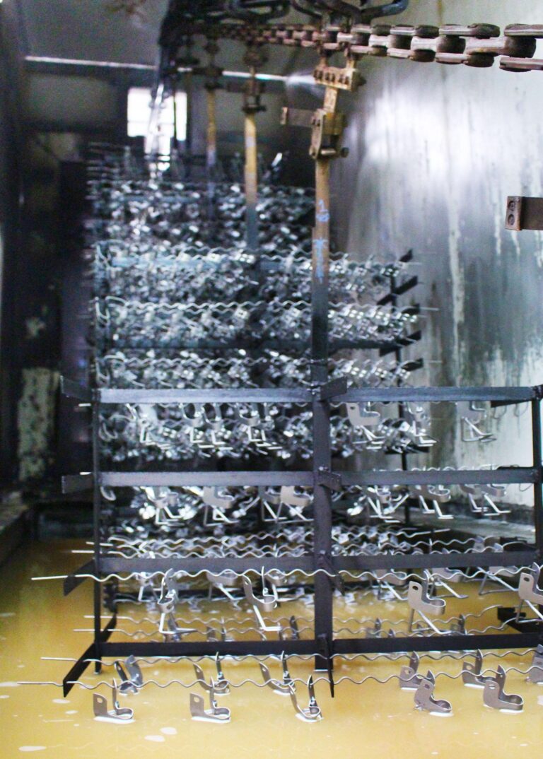 Racked parts in the pre-treatment washing stage